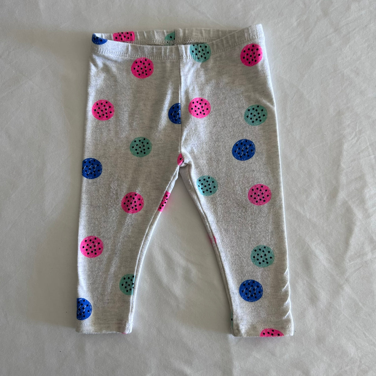 Target Age 00 trousers / leggings in grey, pink, blue, teal with multicoloured polka dots with black dot detail â€” well loved condition.