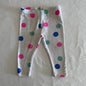 Target Age 00 trousers / leggings in grey, pink, blue, teal with multicoloured polka dots with black dot detail â€” well loved condition.