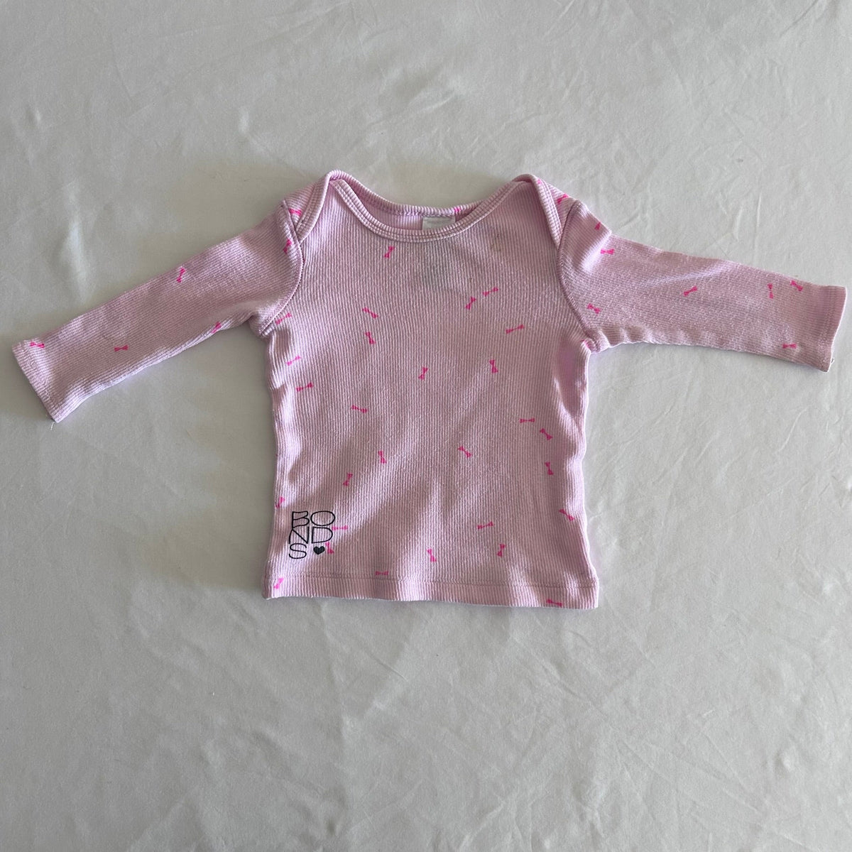 Bonds Age 00 long sleeved top in light pink, hot pink with all-over hot pink bow print â€” well loved condition.
