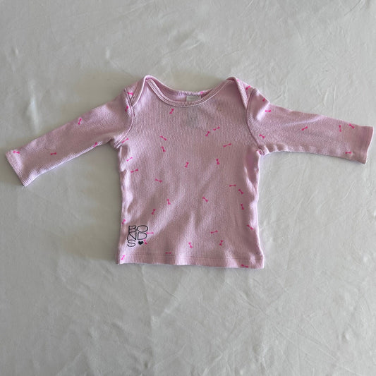 Bonds Age 00 long sleeved top in light pink, hot pink with all-over hot pink bow print â€” well loved condition.