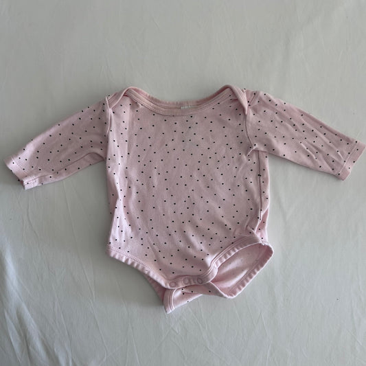 Dymples Age 00 long sleeved snap-crotch bodysuit in pink with small black polka dots, well loved condition.