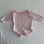Dymples Age 00 long sleeved snap-crotch bodysuit in pink with small black polka dots, well loved condition.