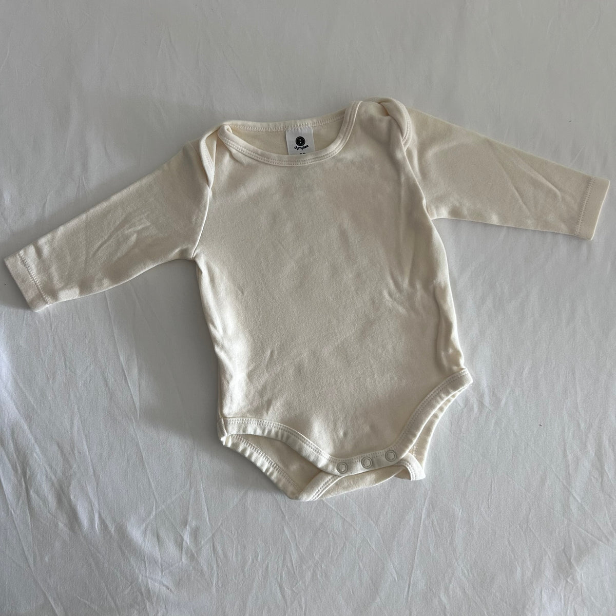Dymples Age 00 long sleeved bodysuit in cream with plain, like new condition.