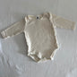 Dymples Age 00 long sleeved bodysuit in cream with plain, like new condition.