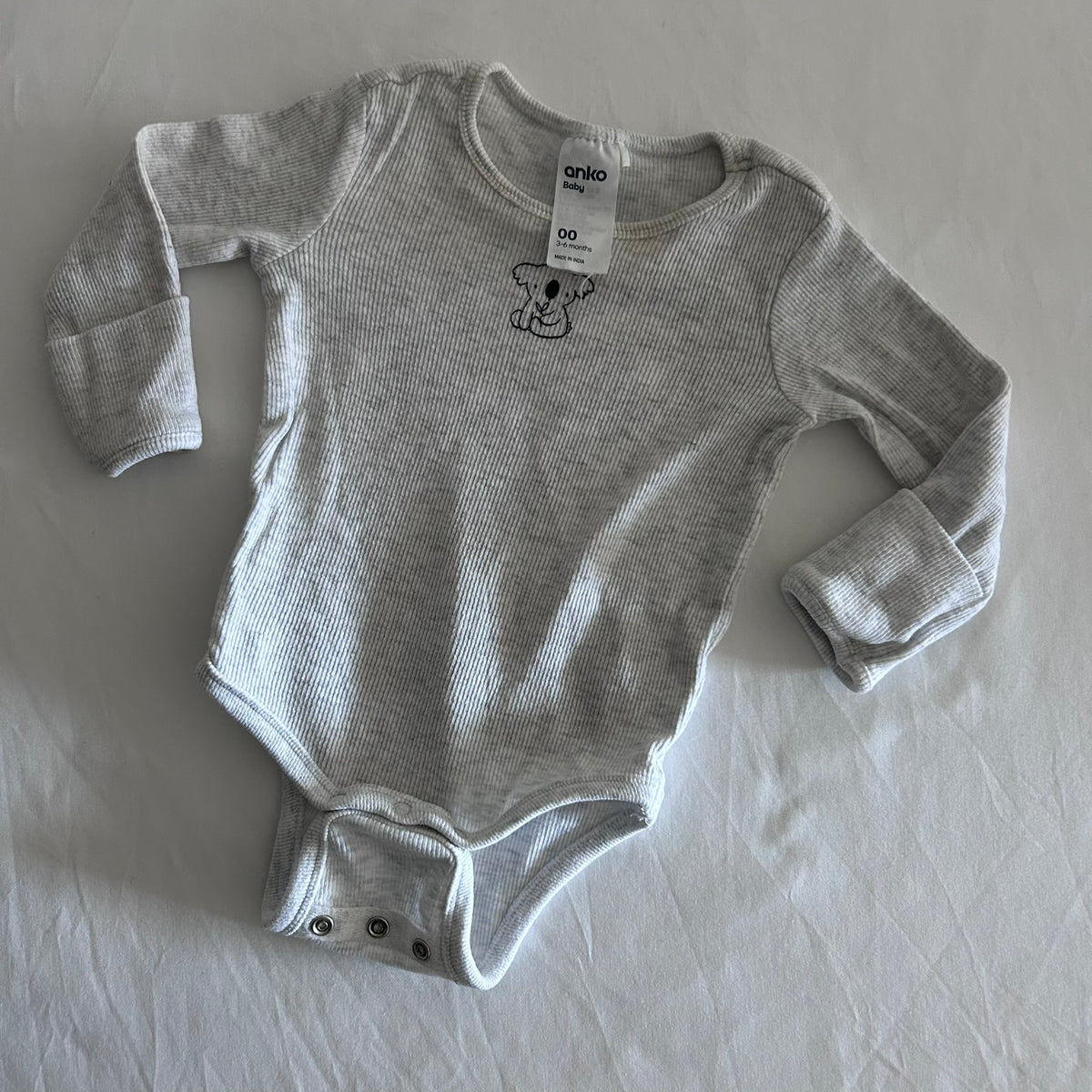 Anko Age 00 long sleeved bodysuit in light grey marl with ribbed stripe, embroidered koala motif on chest, two sets of crotch buttons for different size, fold over sleeves at hands, well loved condition.