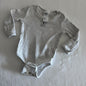 Anko Age 00 long sleeved bodysuit in light grey marl with ribbed stripe, embroidered koala motif on chest, two sets of crotch buttons for different size, fold over sleeves at hands, well loved condition.