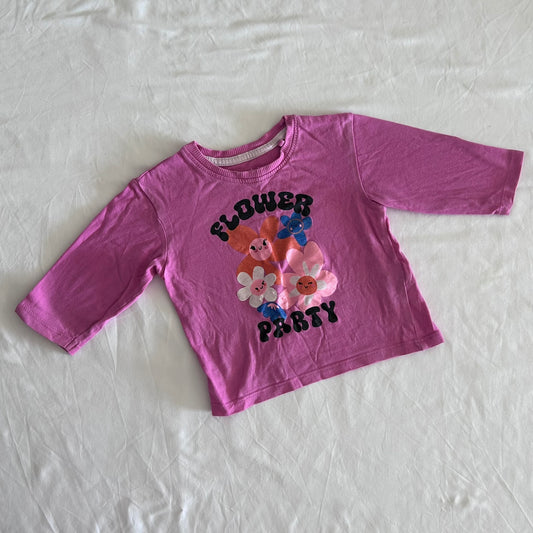 Mango Age 1 long sleeved tee in pink with glitter/foil cartoon flower graphic with text 'flower party' — well loved condition.