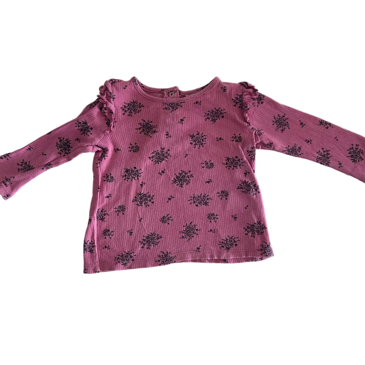 Cotton On Age 1 long sleeved t-shirt in pink, black with floral cluster print, frill trim at sleeves and neckline, snap buttons at back — like new condition.