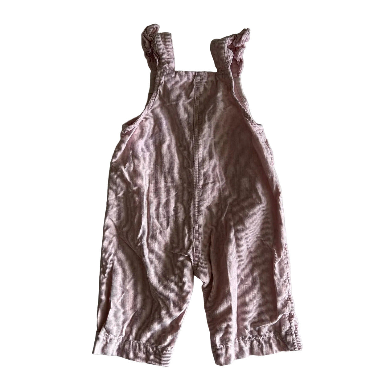 A baby's dusty pink linen overall romper with ruffled shoulder straps, laid flat on a white background.