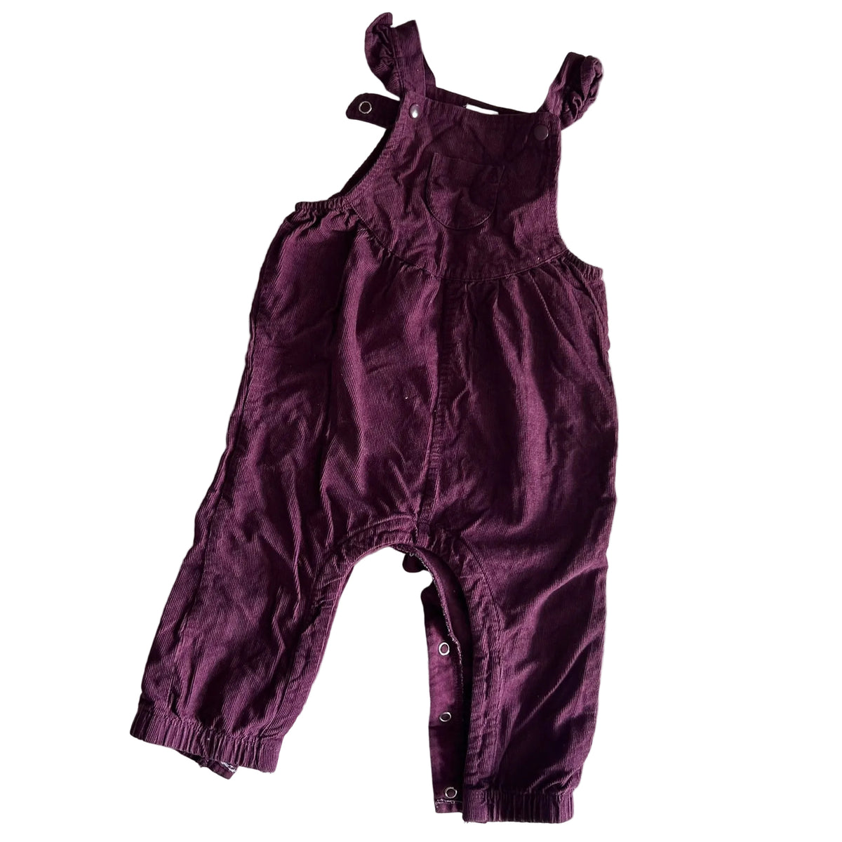 A baby's burgundy corduroy overall romper laid flat on a white background.