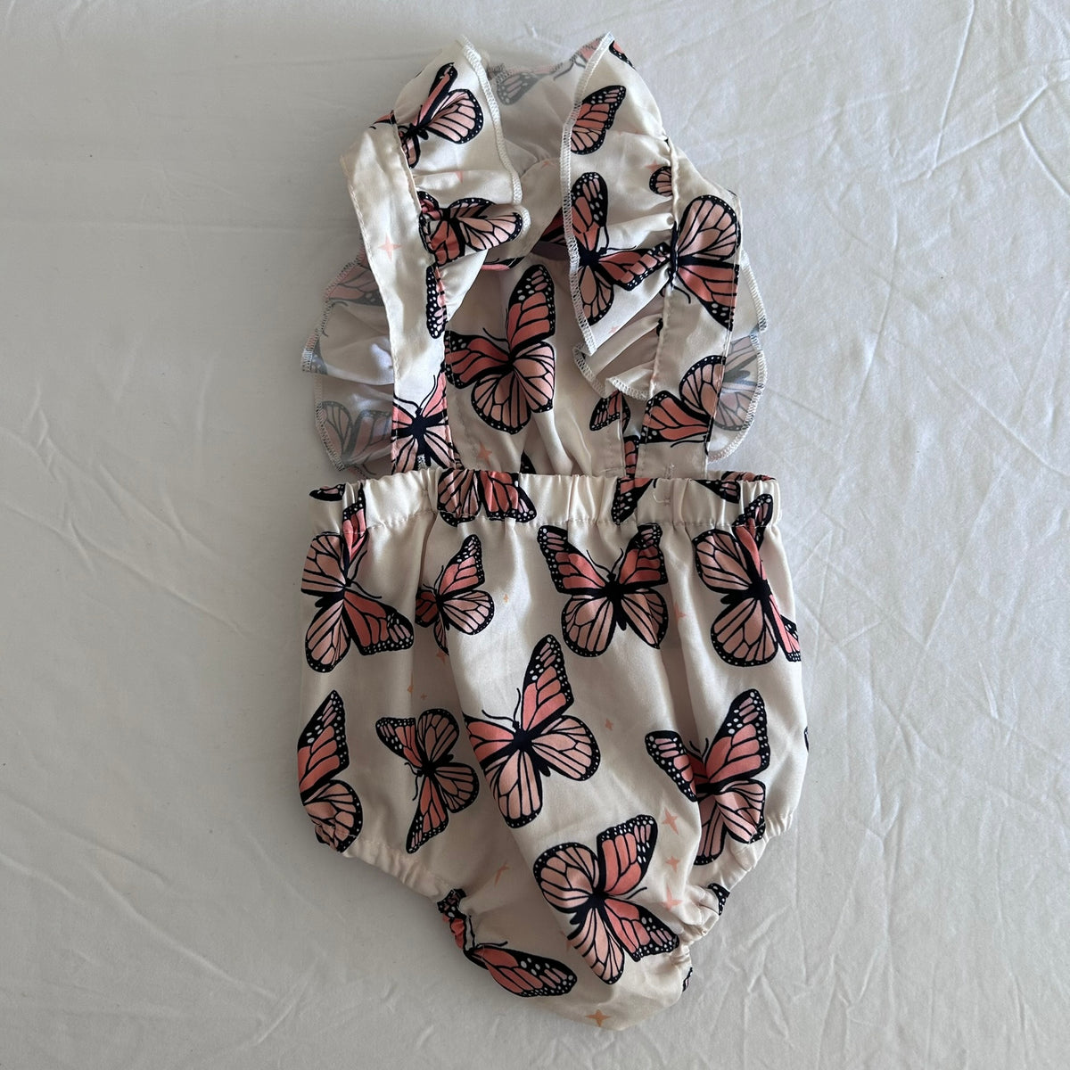 SHEIN Age 000 sleeveless ruffle swimsuit in cream, coral, black with monarch butterfly print — like new condition.