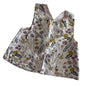 Not branded Age 1 sleeveless pinafore top in white, pink, mustard yellow, purple, black with floral botanical print with wildflowers, leaves, and stems — gently loved condition.