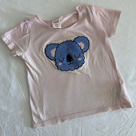 Seed Heritage Age 1 short sleeve t-shirt in light pink, blue, beige with textured chenille koala face appliqué on front — gently loved condition.