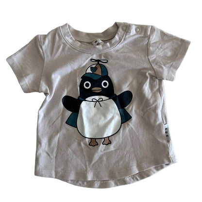 Huxbaby Age 00 short sleeved t-shirt in cream/off-white with penguin graphic print on front — gently loved condition.