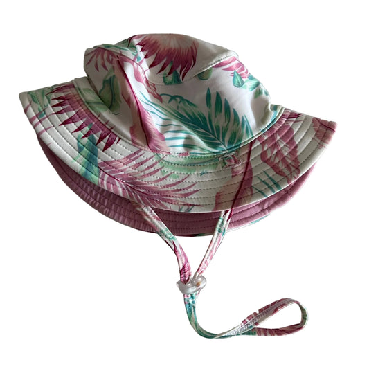Millymook Age 1 wide brim bucket sun hat with chin strap in white, pink, green with tropical floral and palm leaf print, quilted stitching on brim, water resistant — like new condition.