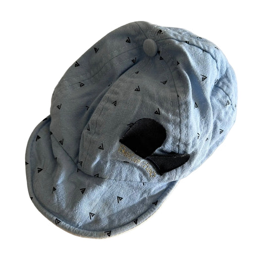 Age 00 bucket hat in light blue, white with all-over small triangle/arrow logo print on blue side, embroidered smiley face on white side, reversible — well loved condition.