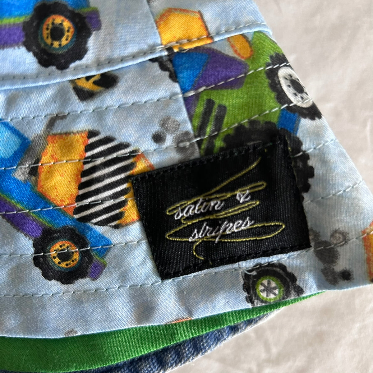 Satin & Stripes Hat Baby Age 00 Blue and Green Construction Vehicles