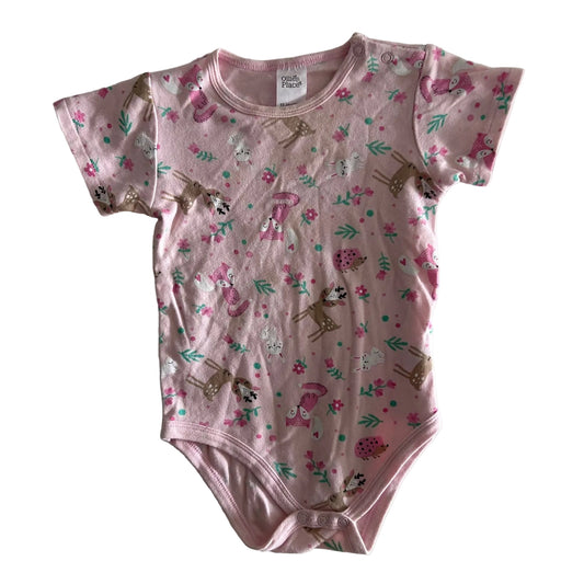 Ollie's Place Age 1 short sleeve bodysuit in pink with woodland animals (foxes, deer, hedgehogs, rabbits) with flowers and foliage — gently loved condition.