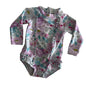 Bebe by Minihaha Age 00 long sleeve zip-up swimsuit / rashie one-piece in white, pink, lilac, teal with floral print with ruffle trim on front, hem and leg openings — gently loved condition.