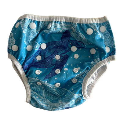 Waladi Age 00 reusable swim nappy in teal, white, navy blue with sea turtle print with mandala/zentangle detail, bubble spots, snap button closures — gently loved condition.