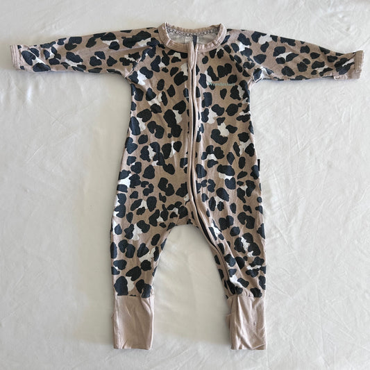 Bonds Age 00 long sleeve zip onesie in tan, black, white with leopard print â€” gently loved condition.