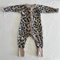 Bonds Age 00 long sleeve zip onesie in tan, black, white with leopard print â€” gently loved condition.