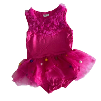 Auggie Age 2 sleeveless tutu romper in hot pink with tulle skirt with multicoloured pom poms, ruffled chest detail — gently loved condition.