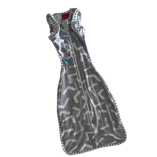 Love To Dream Age 00 swaddle sleep bag / sleep sack in grey and white with abstract brushstroke chevron print with grey and white stripe trim and stripe back pocket — gently loved condition.