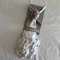 Bunny rabbit comforter neutral tones on a plain pale background 